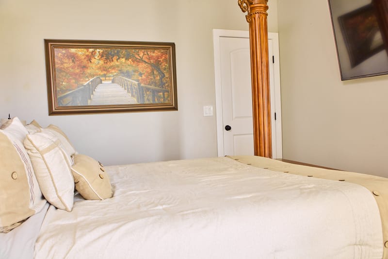The Autumn Room, with a king bed and a framed autumn woodland photograph above it.